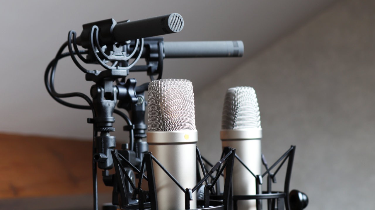 Photo of a pair of RØDE NT1 5th Generation microphones alongside a pair of Schoeps MK4